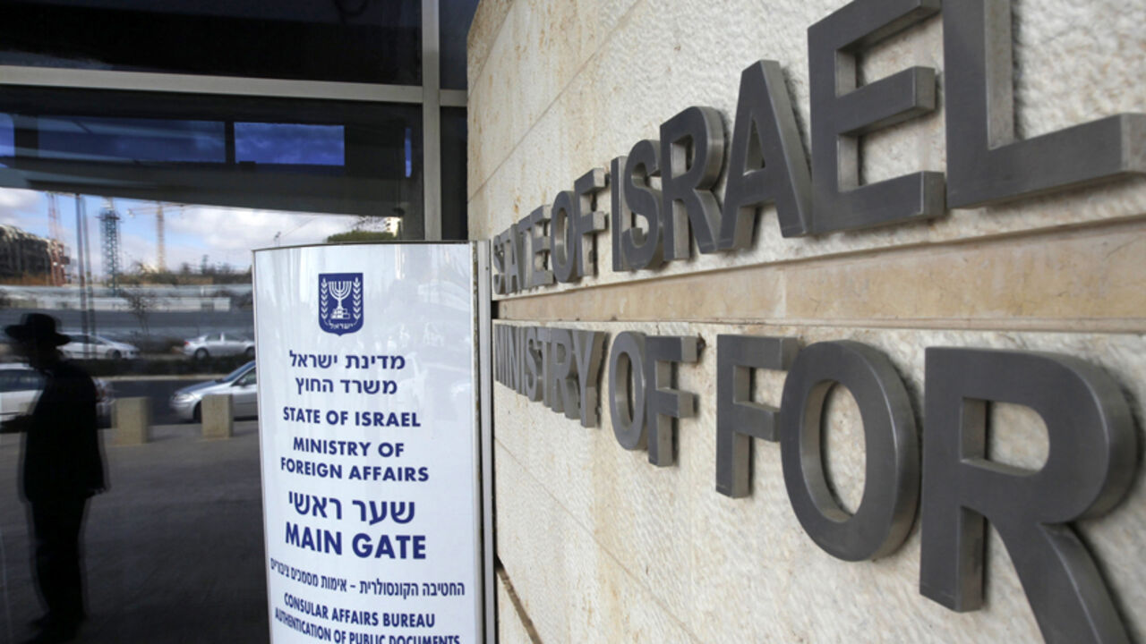 A man is reflected in a window at the entrance to the Israeli Ministry of Foreign Affairs in Jerusalem January 5, 2011. Russia's President Dmitry Medvedev has had to cancel a rare visit to Israel due to a strike at the Israeli foreign ministry, but the strike over pay and working conditions at the ministry, which has foiled three official visits by foreign leaders so far, seems to be having no direct impact on diplomacy aimed at resuscitating Israeli-Palestinian peace. REUTERS/Ronen Zvulun (JERUSALEM - Tags