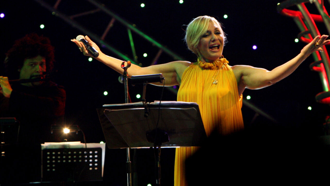 Iranian singer Googoosh, whose real name is Faegheh Atashin, salutes the audience during a rare concert she gave in the Iraqi Kurdish city of Arbil, 320 kms (200 miles) north of Baghdad, late on September 12, 2010. The popular Persian diva was banned from singing along with all female preformers in Iran after the establishment of the Islamic republic in 1979, but she resumed her performances abroad ten years ago.  AFP PHOTO/SAFIN HAMED (Photo credit should read SAFIN HAMED/AFP/Getty Images)
