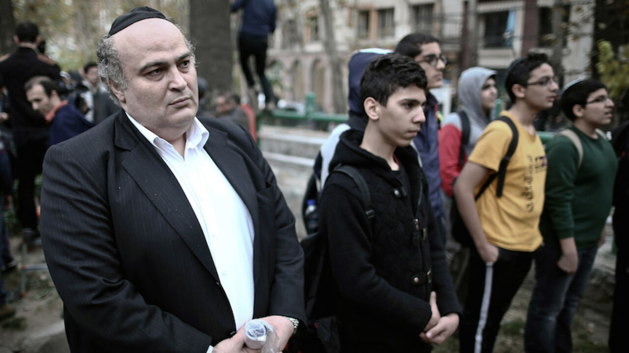 IRAN-NUCLEAR-JEWS-DEMO Iranian Jewish MP Siamak Moreh Sedq (L) and schoolboys read prayers during a demonstration in front of the United Nation's building in Tehran on November 19, 2013 in support of Iran's nuclear program and Iranian negotiators on the eve of the new round of nuclear talks with world powers in Geneva. Talks are scheduled to restart on November 20, as the P5+1 group aims to convince Iran to roll back its work that Western power suspect is masking a military nuclear drive in exchange for some sanctions relief. AFP