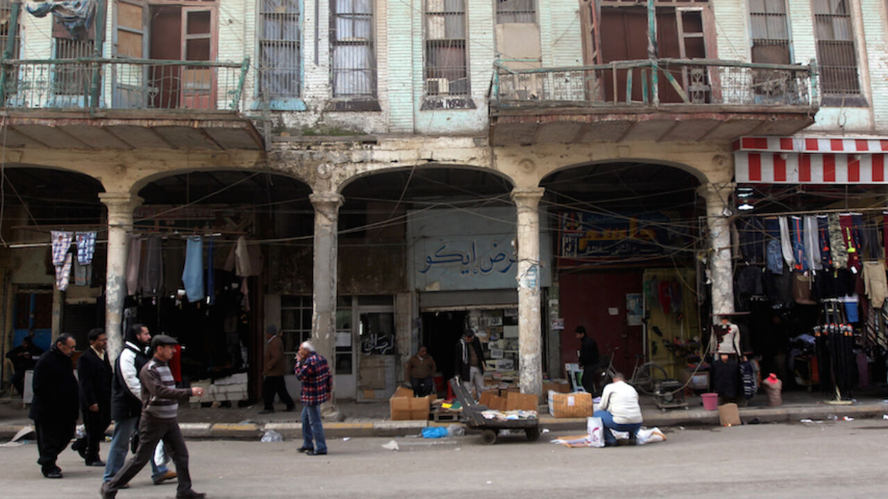 IRAQ-HERITAGE-ARCHITECTURE Iraqis walk past a traditional building in the oldest alley of the capital Baghdad on December 13, 2013. Baghdad was once the capital of an empire and the centre of the Islamic world, but at 1,250 years old, the Iraqi city is a far cry from its past glories after being ravaged by years of war and sanctions. AFP PHOTO/AHMAD AL-RUBAYE (Photo credit should read AHMAD AL-RUBAYE/AFP/Getty Images)