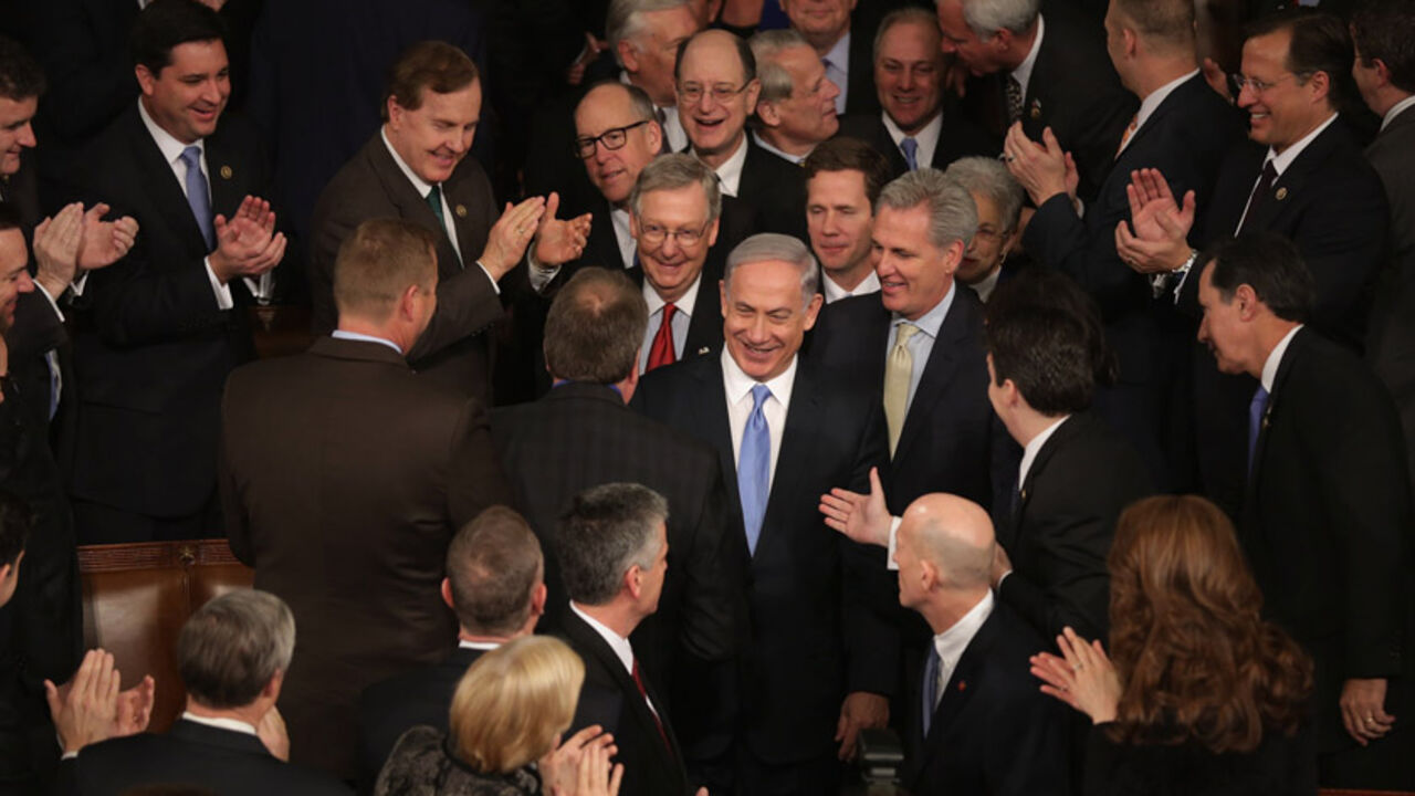 84133533 WASHINGTON, DC - MARCH 03: Israeli Prime Minister Benjamin Netanyahu (C) is greeted by members of Congress as he arrives to speak during a joint meeting of the United States Congress in the House chamber at the U.S. Capitol March 3, 2015 in Washington, DC. At the risk of further straining the relationship between Israel and the Obama Administration, Netanyahu warned members of Congress against what he considers an ill-advised nuclear deal with Iran. (Photo by Chip Somodevilla/Getty Images)