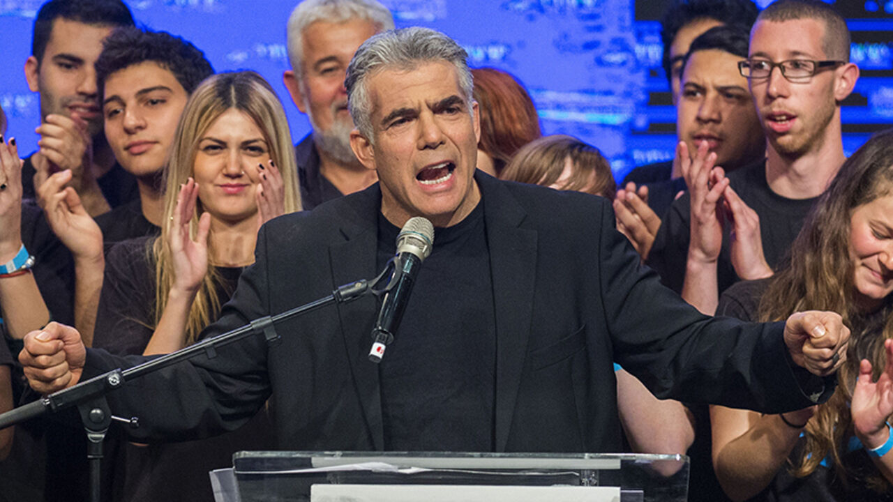 Nic6411249 Israeli MP and chairperson of center-right Yesh Atid party, Yair Lapid, delivers a speech outlining the Yesh Atid campaign and presenting the party's list for the 20th Knesset, on January 26, 2015 in the Israeli city of Rishon Letzion, ahead of the March 17 general elections. AFP PHOTO /JACK GUEZ (Photo credit should read JACK GUEZ/AFP/Getty Images)