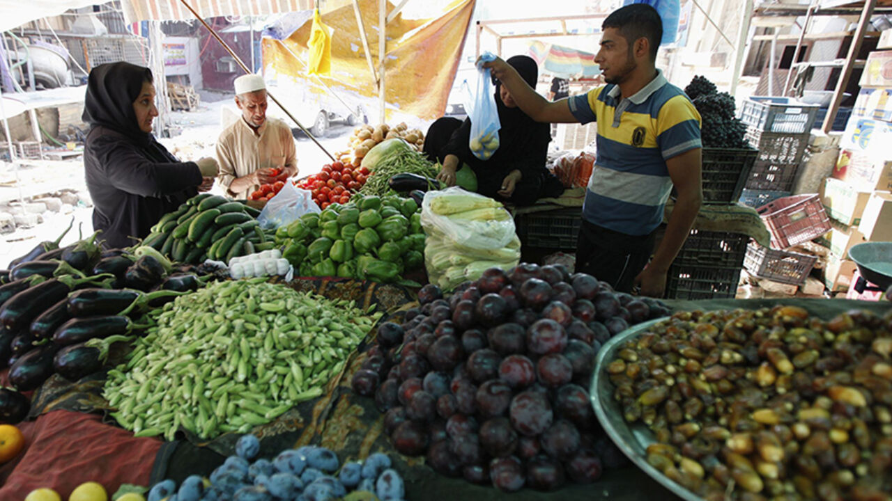 SYRIA-CRISIS/IRAQ Residents buy vegetables in a market in Baghdad's Karrada district August 14, 2012. Iraq relies on imports from neighbours like Syria, Turkey and Iran for 95 percent of its consumer goods. Syria in particular is a key supplier of manufactured goods, fresh vegetables and fruit. But as an uprising there against President Bashar al-Assad grinds through its 17th month, the supply of Syrian goods to Iraq is slowly drying up as Syrian businesses are forced to close and trucks struggle to cross borders that have s