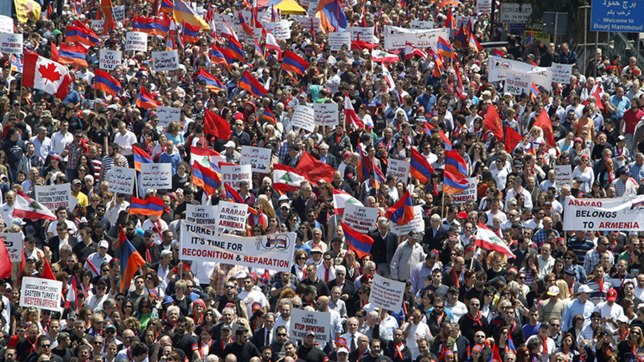 LEBANON/ Lebanese of Armenian descent carry banners as they wave Lebanese and Armenian flags during a march from Bourj Hammoud to downtown Beirut's Martyrs Square, April 24, 2013, to mark the 98th anniversary of the mass killing of Armenians in the Ottoman Empire in 1915. REUTERS/Sharif Karim (LEBANON - Tags: POLITICS CIVIL UNREST) - RTXYXYB