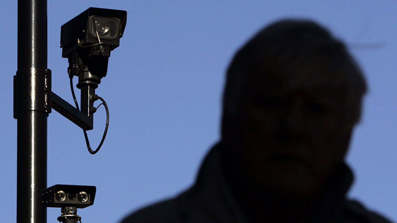 BRITAIN PRIVACY A security camera overlooks a man as he walks down a street in London November 2, 2006. Britain is becoming a surveillance society where individuals are filmed hundreds of times a day by CCTV and where companies "data mine" to build up profiles on customers, the Information Commissioner warned on Thursday. REUTERS/Luke MacGregor (BRITAIN) - RTR1IXR5