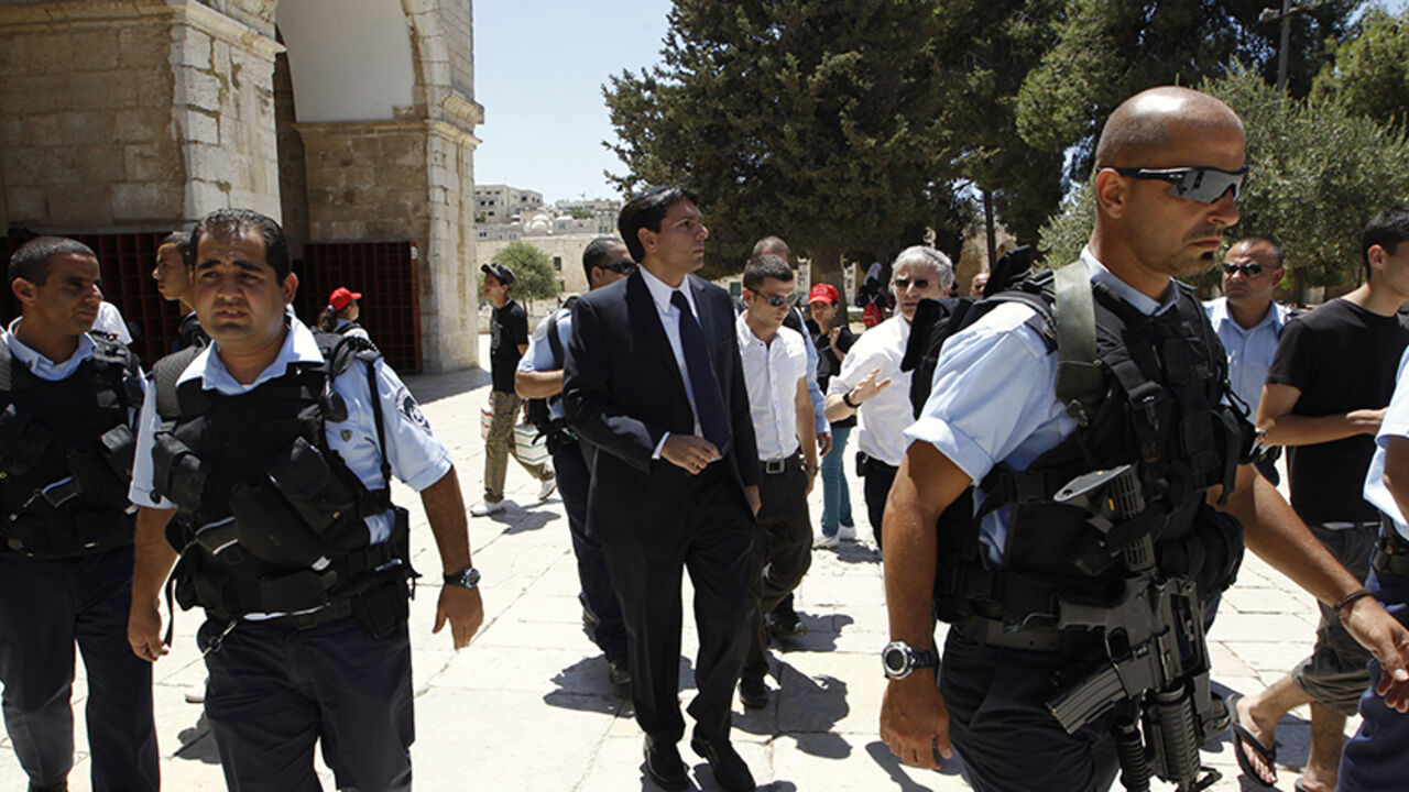 PALESTINIANS-ISRAEL/JERUSALEM Israeli lawmaker Danny Danon (C), a deputy parliament speaker, is surrounded by police officers as he walks on the compound known to Muslims as al-Haram al-Sharif and to Jews as Temple Mount, in Jerusalem's Old City July 20, 2010. Danon, a lawmaker of Prime Minister Benjamin Netanyahu's right-wing party, on Tuesday visited the flashpoint religious site in Jerusalem revered by Jews and Muslims, a move that has sparked violence in the past. REUTERS/Ammar Awad (JERUSALEM - Tags: POLITICS RELIGION) - RTR2GKI0