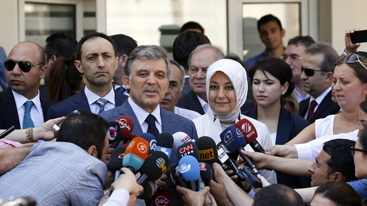 TURKEY-ELECTION/ Turkey's incumbent President Abdullah Gul and his wife Hayrunnisa Gul talk to the media as they leave a polling station after casting their votes in Ankara August 10, 2014. Turks began voting on Sunday with Tayyip Erdogan poised to become the country's first elected president, fulfilling his dream of what he calls a "new Turkey" and his opponents say will be an increasingly authoritarian nation. REUTERS/Umit Bektas (TURKEY - Tags: POLITICS ELECTIONS) - RTR41UXL