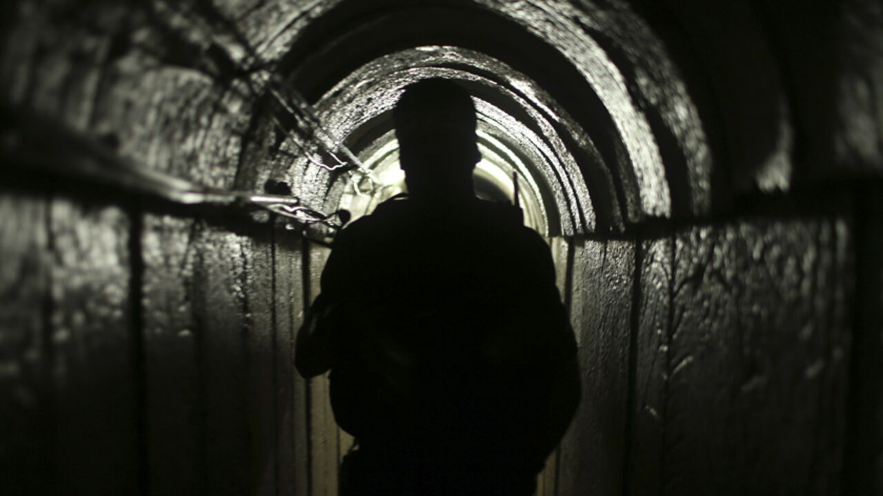 MIDEAST-GAZA/TUNNELS A Palestinian fighter from the Izz el-Deen al-Qassam Brigades, the armed wing of the Hamas movement, is seen inside an underground tunnel in Gaza August 18, 2014. A rare tour that Hamas granted to a Reuters reporter, photographer and cameraman appeared to be an attempt to dispute Israel's claim that it had demolished all of the Islamist group's border infiltration tunnels in the Gaza war. Picture taken August 18, 2014. To match Exclusive MIDEAST-GAZA/TUNNELS REUTERS/Mohammed Salem (GAZA - Tags: