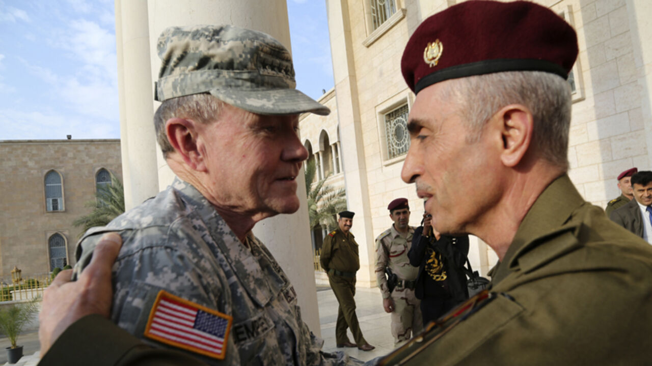 MIDEAST-CRISIS/IRAQ-USA Iraq's army chief General Babakir Zebari (R) meets with U.S. Army General Martin Dempsey, chairman of the Joint Chiefs of Staff, at the defence ministry in Baghdad November 15, 2014. The top U.S. military officer, Dempsey, arrived on Saturday in Baghdad on an unannounced visit as U.S. commanders prepare to expand American assistance to Iraqi and Kurdish forces battling the Islamic State. REUTERS/Stringer (IRAQ - Tags - Tags: CIVIL UNREST POLITICS MILITARY) - RTR4E9AP
