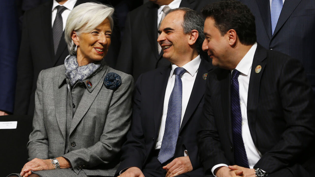 IMF Managing Director Lagarde chats with Turkey's Deputy PM Babacan and Turkish Central Bank Governor Basci during a family photo session at the G20 finance ministers and central bank governors meeting in Istanbul International Monetary Fund (IMF) Managing Director Christine Lagarde (L) chats with Turkey's Deputy Prime Minister Ali Babacan (R) and Turkish Central Bank Governor Erdem Basci (C) during a family photo session at the G20 finance ministers and central bank governors meeting in Istanbul February 10, 2015. The United States urged a meeting of the Group of 20 leading economies not to resort to currency devaluations to boost exports, while a draft communique gave a gloomy assessment on Tuesday of the outlook f