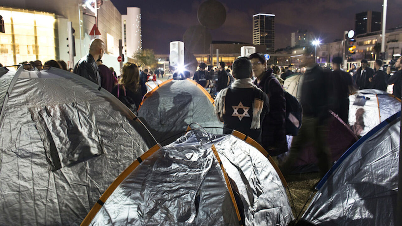 Israeli activists stand near tents on a main boulevard in the coastal city of Tel Aviv Israeli activists stand near tents on a main boulevard in the coastal city of Tel Aviv March 1, 2015. Dozens of Israeli social activists pitched tents in Tel Aviv on Sunday protesting about a housing shortage which is a key issue in campaigning for a March 17 election. The protest was reminiscent of a similar demonstration against a housing shortage in 2011 that ignited social protests of unprecedented size in Israel. REUTERS/Nir Elias (ISRAEL - Tags: POLITICS CIVIL UNREST) - RTR4RNTC