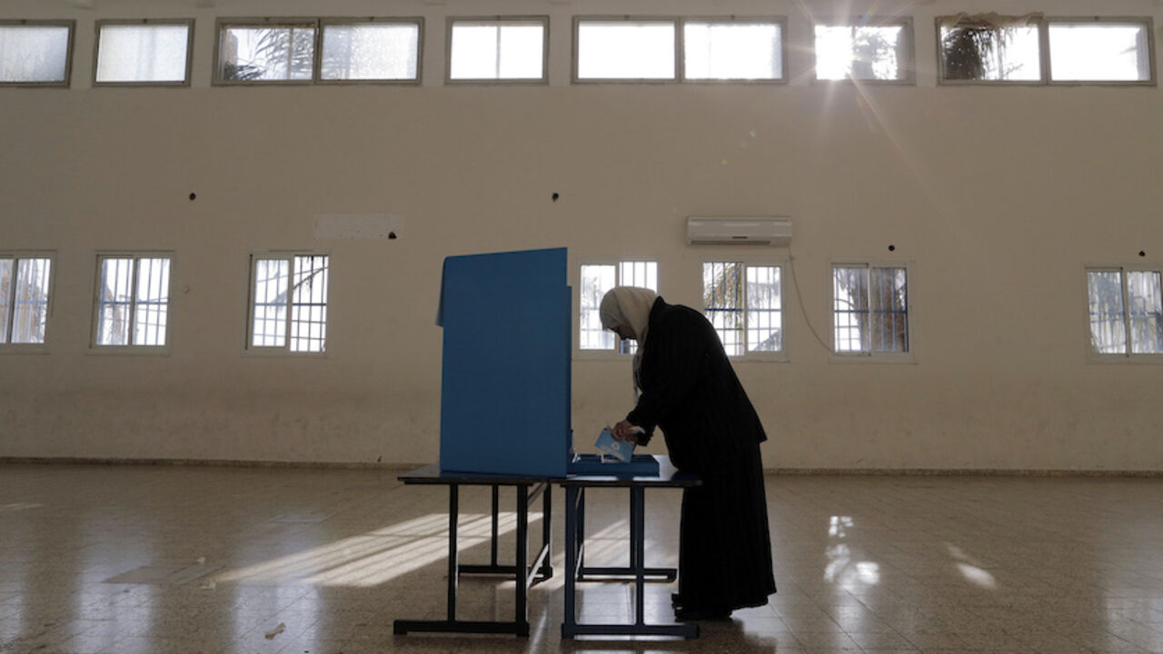 An Israeli Arab stands behind a voting booth before casting her ballot at a polling station in the northern town of Umm el-Fahm March 17, 2015. Millions of Israelis turned out to vote on Tuesday in a tightly-fought election, with Prime Minister Benjamin Netanyahu facing an uphill battle to defeat a strong campaign by the centre-left opposition to deny him a fourth term in office. In a possible sign of edginess, Netanyahu took to Facebook to denounce what he said was an effort by left-wing non-profit groups 