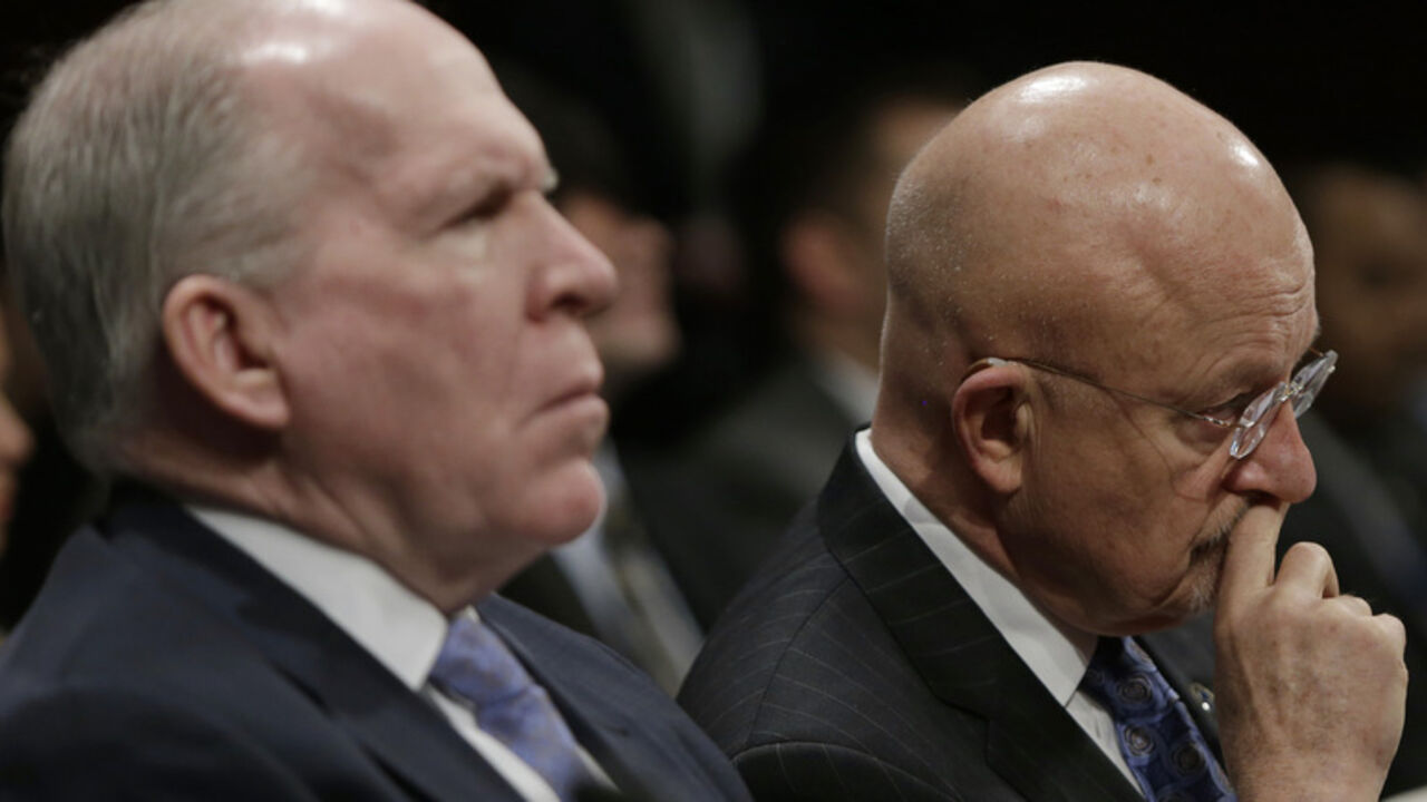 Director of U.S. National Intelligence James Clapper (R) and CIA Director John Brennan (L) listen to opening remarks at the House Intelligence Committee on "Worldwide Threats", in Washington February 4, 2014.        REUTERS/Gary Cameron  (UNITED STATES - Tags: CRIME LAW POLITICS MILITARY) - RTX187SF