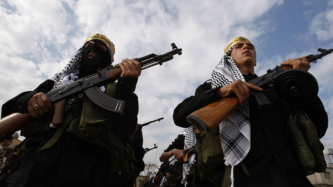 LEBANON/ Palestinian Fatah members march during a parade at Ain el-Hilweh refugee camp, southern Lebanon, to mark the 46th anniversary of founding the Fateh movement, December 31, 2010. REUTERS/Ali Hashisho (LEBANON - Tags: ANNIVERSARY CIVIL UNREST) - RTXW41O