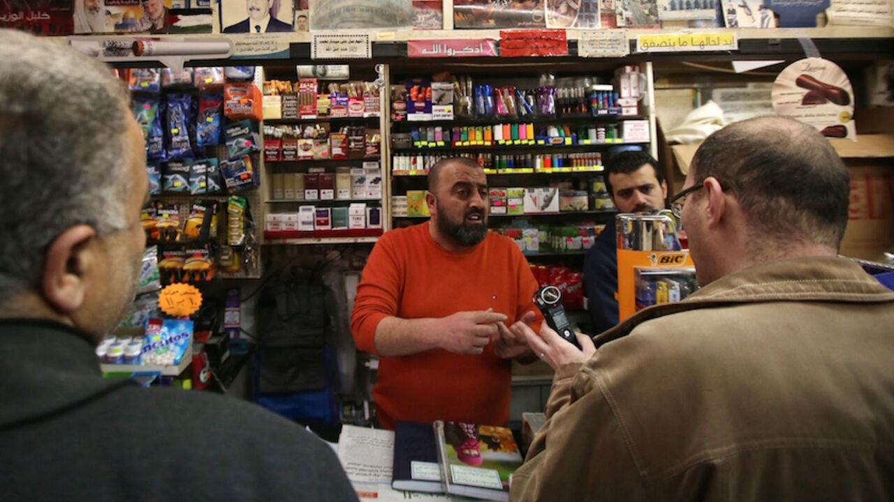 Nic6421180 Supporters of the Palestinian Fatah movement talk with a shop keeper at a shop during a visit to convince retailers not to sell Israeli goods on February 24, 2015 in the West Bank city of Ramallah. A Palestinian commission launched a new campaign calling for the boycott of Israeli products in reaction to sanctions imposed by Israel following the recent Palestinian diplomatic offensive at the United Nations, the head of the commission told AFP. AFP PHOTO / ABBAS MOMANI (Photo credit should read ABBAS