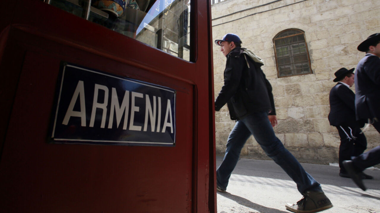 Nic6443325 Tourists and Israelis walk past Lepejian ceramics shop, which specializes in making traditional hand painted Armenian pottery, on April 17, 2015 at the Armenian Quarter in Jerusalem's Old City. Armenians around the world will mark on April 24, 2015 the centenary of the World War I-era mass killings of their kin by Ottoman Turks in what they insist was a genocide -- a term fiercely rejected by Turkey. AFP PHOTO / GALI TIBBON (Photo credit should read GALI TIBBON/AFP/Getty Images)