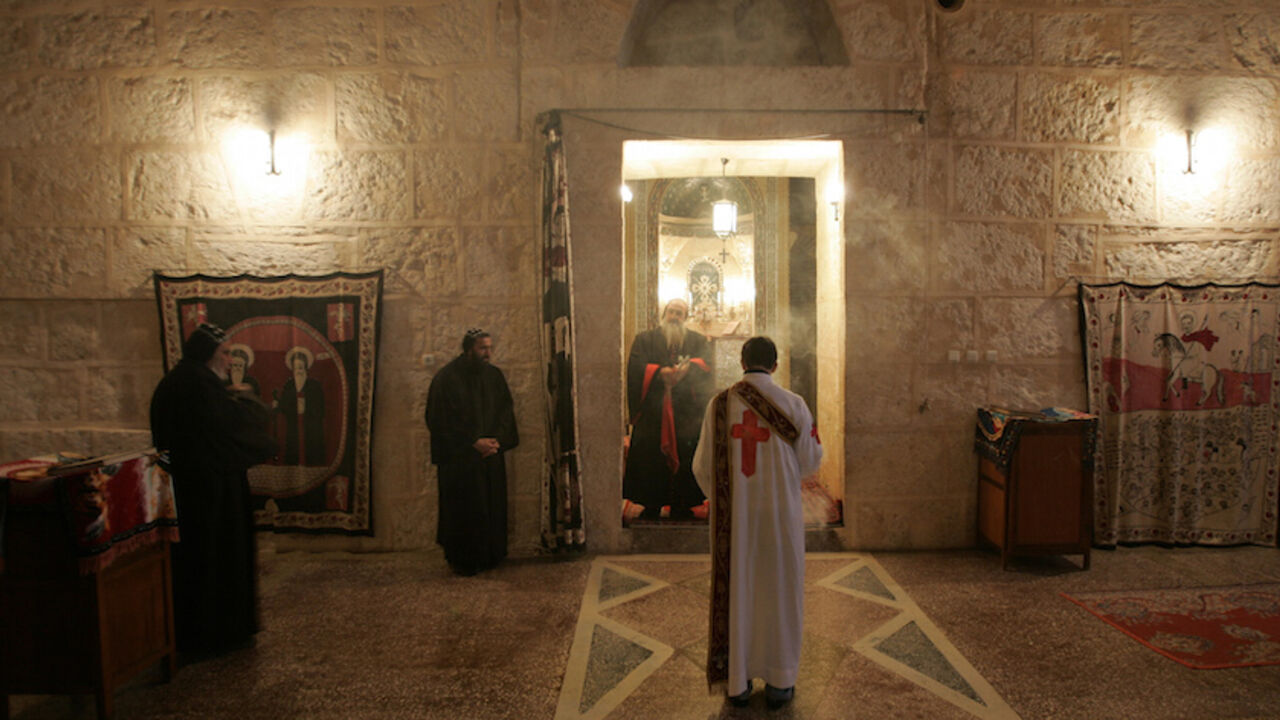 RELIGION-TURKEY/CHRISTIANS Syriac Christian monks attend a service at the ancient monastery of Mor Gabriel, 15 km (9 miles) away from the town of Midyat, in Mardin province of southeast Turkey January 13, 2009. Tucked amid rugged hills where mosques and minarets are silhouetted in the distance, the fifth century Mor Gabriel monastery stands out as a relic of another era when hundreds of thousands of Syriac Christians lived and worshipped in Turkey. But a land dispute between Mor Gabriel and neighbouring villages is threatening the mo