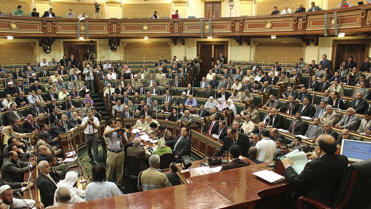 EGYPT/ Parliament members talk during a session at the parliament building in Cairo, July 10, 2012. Egypt's Islamist-led parliament reconvened on Tuesday in an open challenge to the generals who dissolved the assembly last month, stirring up tensions with the military just 10 days into Mohamed Mursi's presidency. REUTERS/Stringer (EGYPT - Tags: POLITICS) - RTR34SOH