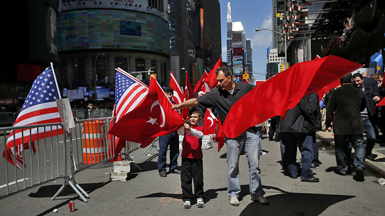 USA/ People take part in a protest in support of Turkey's position on the 1915 mass killing of Armenians in the Ottoman Empire, at Times Square in New York April 26, 2014. The exact nature and scale of what happened during fighting that started in 1915 is highly contentious and continues to sour relations between Turkey and Armenia, a former Soviet republic. Turkey accepts that many Armenians died in clashes, but denies that up to 1.5 million were killed and that this constituted an act of genocide - a term use
