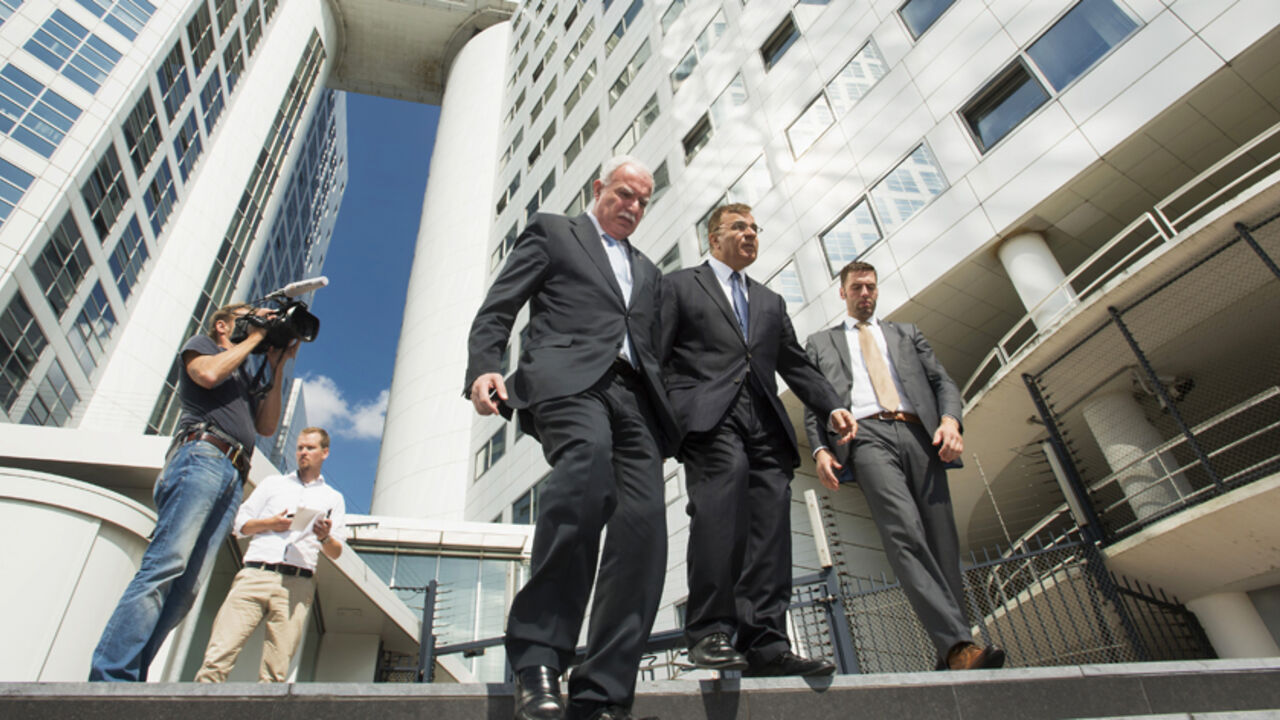 Palestinian Foreign Minister Riad al-Malki (C) leaves the International Criminal Court (ICC) at the Hague August 5, 2014. Al-Malki said on Tuesday after meeting prosecutors at the International Criminal Court that there was "clear evidence" that Israel committed war crimes in Gaza. The visit took place shortly after Israeli and the Islamist Hamas movement entered a 72-hour truce mediated by Egypt in an effort to pave the way for an extended ceasefire. Israel and the Palestinians have traded allegations of w