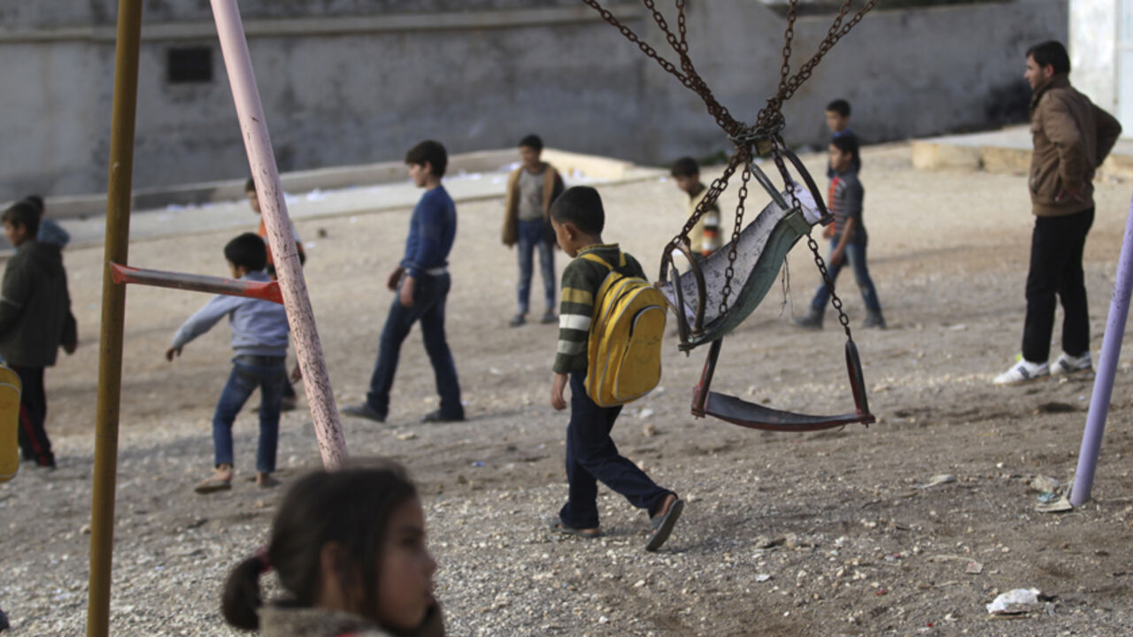 Children who were internally displaced from Hama and Idlib, walk in a makeshift school playground within a refugee camp beside the Syrian-Turkish border in Qtma town, Idlib countryside December 18, 2014. Picture taken December 18, 2014. 
REUTERS/Khalil Ashawi (SYRIA - Tags: POLITICS CIVIL UNREST CONFLICT) - RTR4IO28