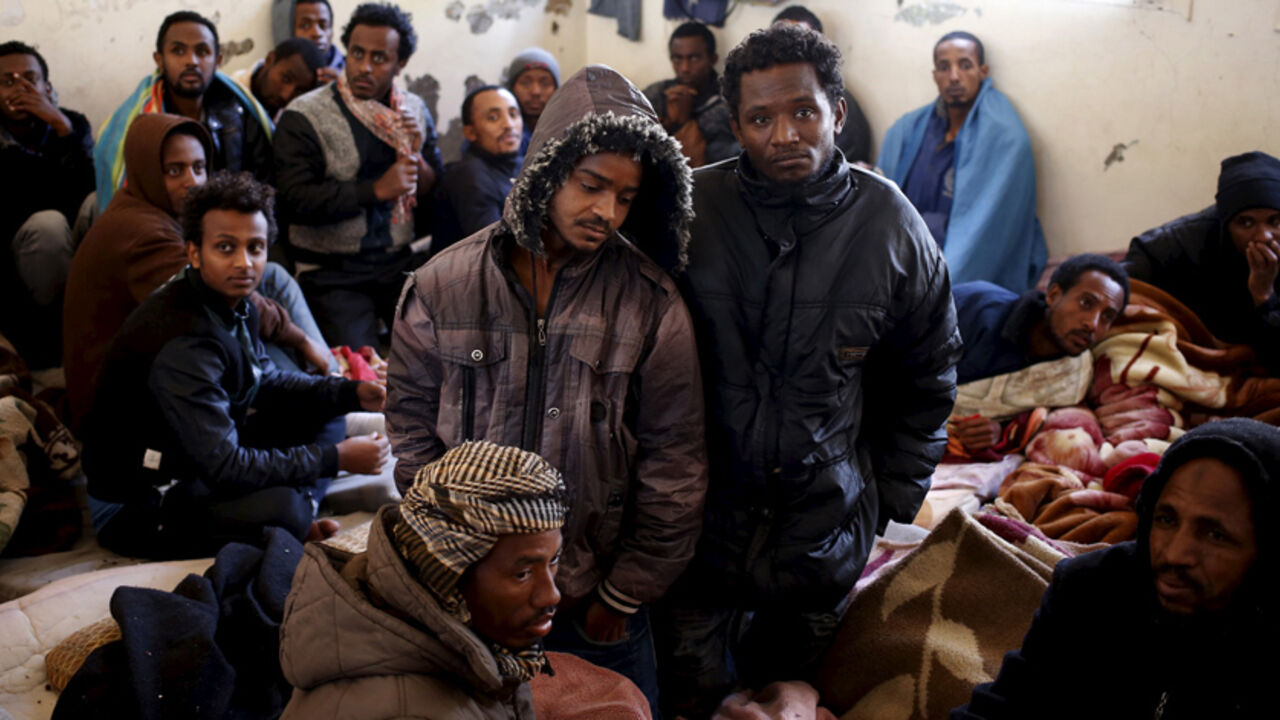 LIBYA-MIGRANTS/ Illegal migrants sit in an immigration holding centre located on the outskirts of Misrata March 11, 2015. Italy wants Egypt and Tunisia to play a role in rescuing stricken migrant vessels in the Mediterranean, a government planning paper showed, so that survivors could be taken back to African instead of European ports. Last April Italy rescued 4,000 migrants from boats trying to reach European shores in only 48 hours in a deepening immigration crisis that is being made worse by the turmoil in Libya, which