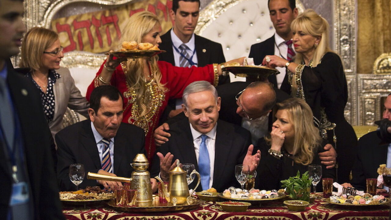 ISRAEL-NETANYAHU/ Israeli Prime Minister Benjamin Netanyahu (C) and his wife Sara (2nd R) attend the Mimona ceremony at the Israeli town of Or Akiva near Caesarea April 11, 2015. Mimona is traditionally celebrated by Jews from North Africa at the end of the Passover holidays. REUTERS/Amir Cohen - RTR4WY31