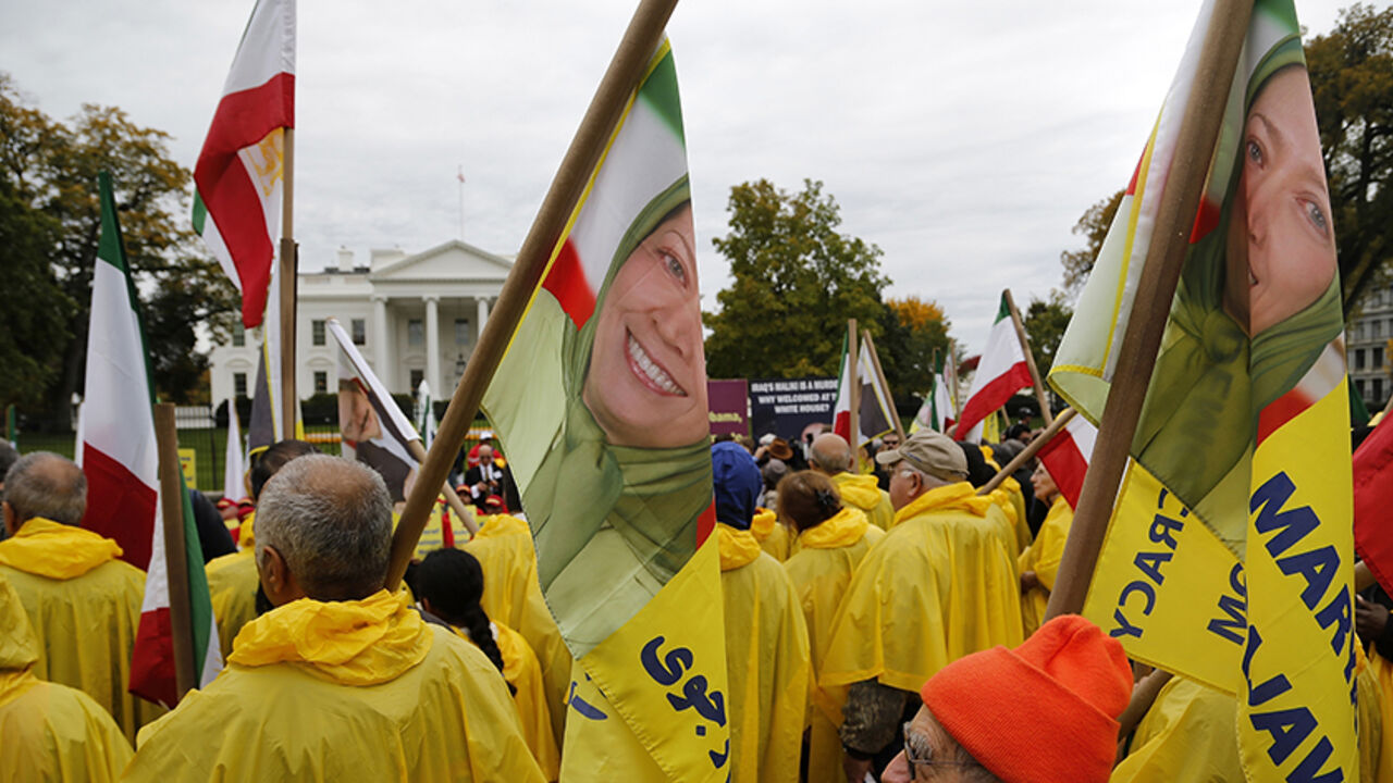 USA/ Supporters of Iranian opposition group Mujahedin-e Khalq (MEK) hold flags showing Maryam Rajavi, head of the National Council of Resistance of Iran (NCRI), as they rally against Iraq's Prime Minister Nuri al-Maliki hours before he is scheduled to meet with U.S. President Barack Obama, at the White House in Washington, November 1, 2013. The MEK fought on the side of former Iraqi leader Saddam Hussein during the 1980-88 Iran-Iraq war, mounting attacks on Iran from Iraq, and are calling for the U.S. to hold Ir