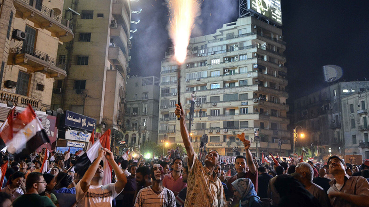 Was7697048 An Egyptian protester lights up a flare as hundreds of thousands of Egyptian demonstrators gather in Cairo's landmark Tahrir square during a protest calling for the ouster of President Mohamed Morsi on July 1, 2013. Egypt's armed forces warned that it will intervene if the people's demands are not met within 48 hours, after millions took to the streets to demand the president's resignation. AFP PHOTO/MOHAMED EL-SHAHED (Photo credit should read MOHAMED EL-SHAHED/AFP/Getty Images)