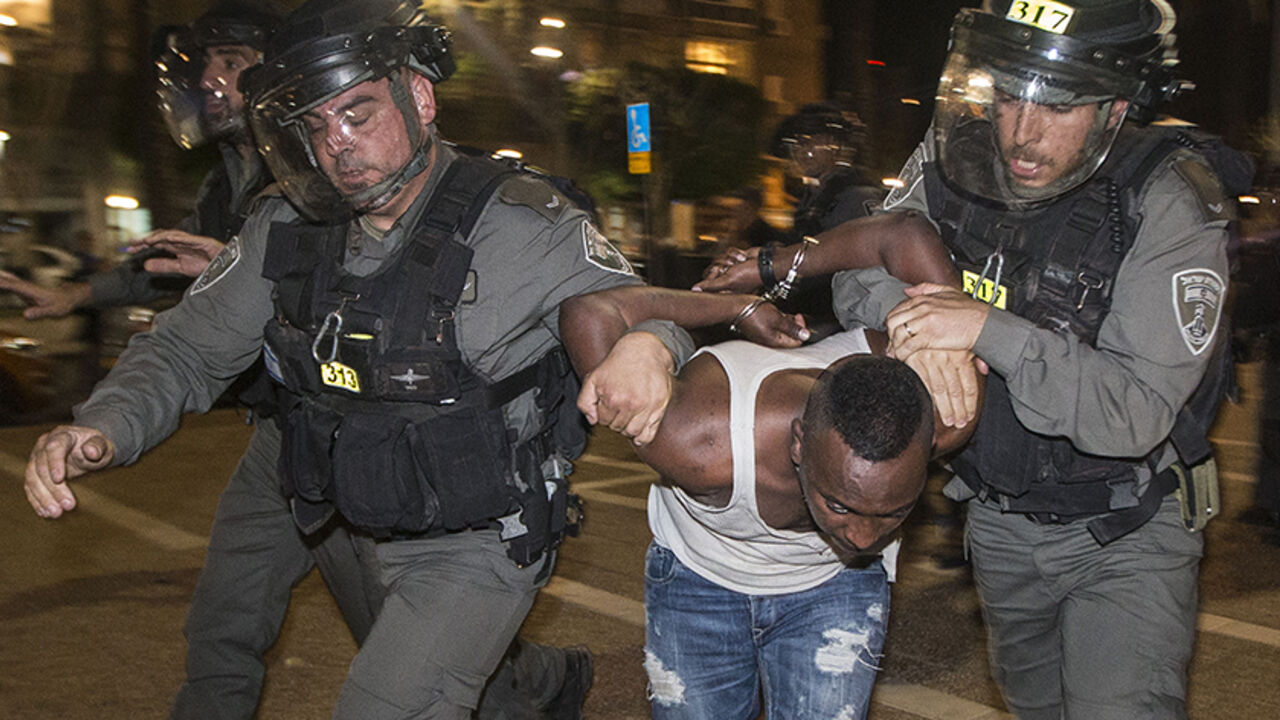 Par8164481 Israeli security forces arrest an Israeli man from the Ethiopian community in the coastal city of Tel Aviv, on May 3, 2015, during a protest against alleged police brutality and institutionalised discrimination. The protest came three days after a stormy demonstration in Jerusalem sparked by footage showing two police officers beating an Israeli soldier of Ethiopian origin in uniform. More than 135,000 Ethiopian Jews live in Israel, having immigrated to the Jewish state in two waves in 1984 and 1991. AFP PH