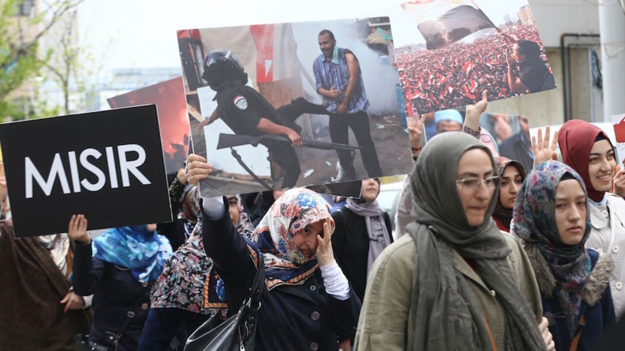 Par7858373 Supporters of the Egyptian Muslim Brotherhood take part in a rally to protest against the death penalties for the members of the radical group in Egypt, near the Egyptian embassy in Ankara on April 18, 2014. AFP PHOTO / ADEM ALTAN (Photo credit should read ADEM ALTAN/AFP/Getty Images)