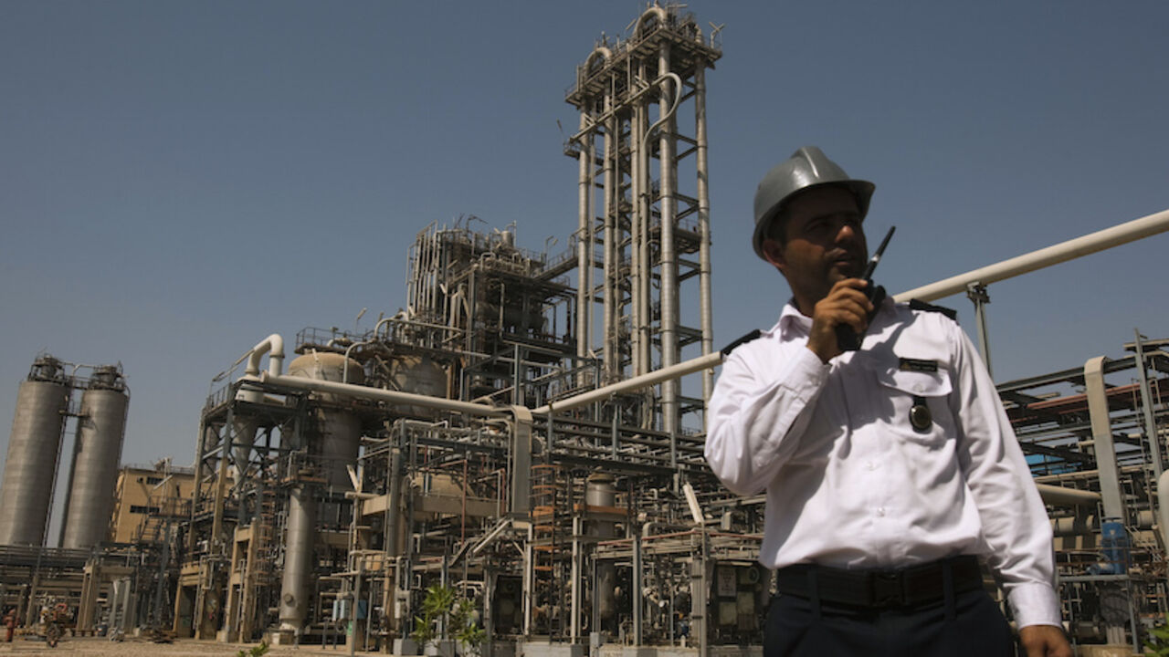 IRAN/ A security personnel stands in front of the Mahshahr petrochemical plant in Khuzestan province,1032 km (641 miles) southwest of Tehran, September 28, 2011. REUTERS/Raheb Homavandi (IRAN - Tags: BUSINESS ENERGY INDUSTRIAL) - RTR2RYWC