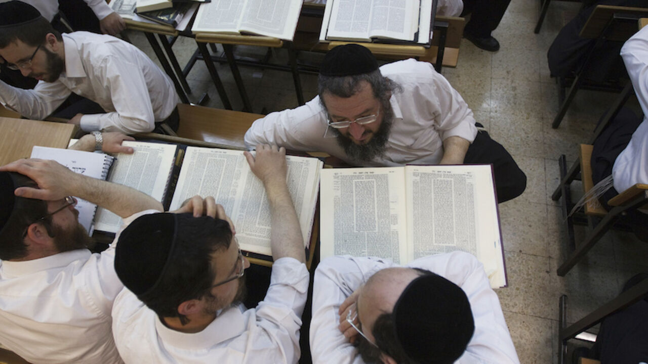 Ultra-Orthodox Jewish men study at Jerusalem's Mir Yeshiva, the largest Jewish seminary in Israel July 4, 2012. The ultra-Orthodox Jews have gone from being a tiny minority in Israel's mostly secular society to its fastest-growing sector, now about 10 percent of the 7.8 million population. They are exempt from military duty in Israel but draft deferments and state subsidies for the ultra-Orthodox have become a divisive political issue in Israel, where the government must decide a new law by August to ensure