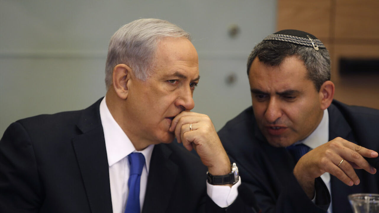 Israel's Prime Minister Benjamin Netanyahu (L) listens to Foreign Affairs and Defence committee chair Zeev Elkin during a committee meeting at parliament in Jerusalem June 2, 2014. Netanyahu warned on Sunday against any international rush to recognise a Palestinian government due to be announced under a unity pact between the Fatah and Hamas Islamist groups.REUTERS/Ronen Zvulun (JERUSALEM - Tags: POLITICS) - RTR3RRU6