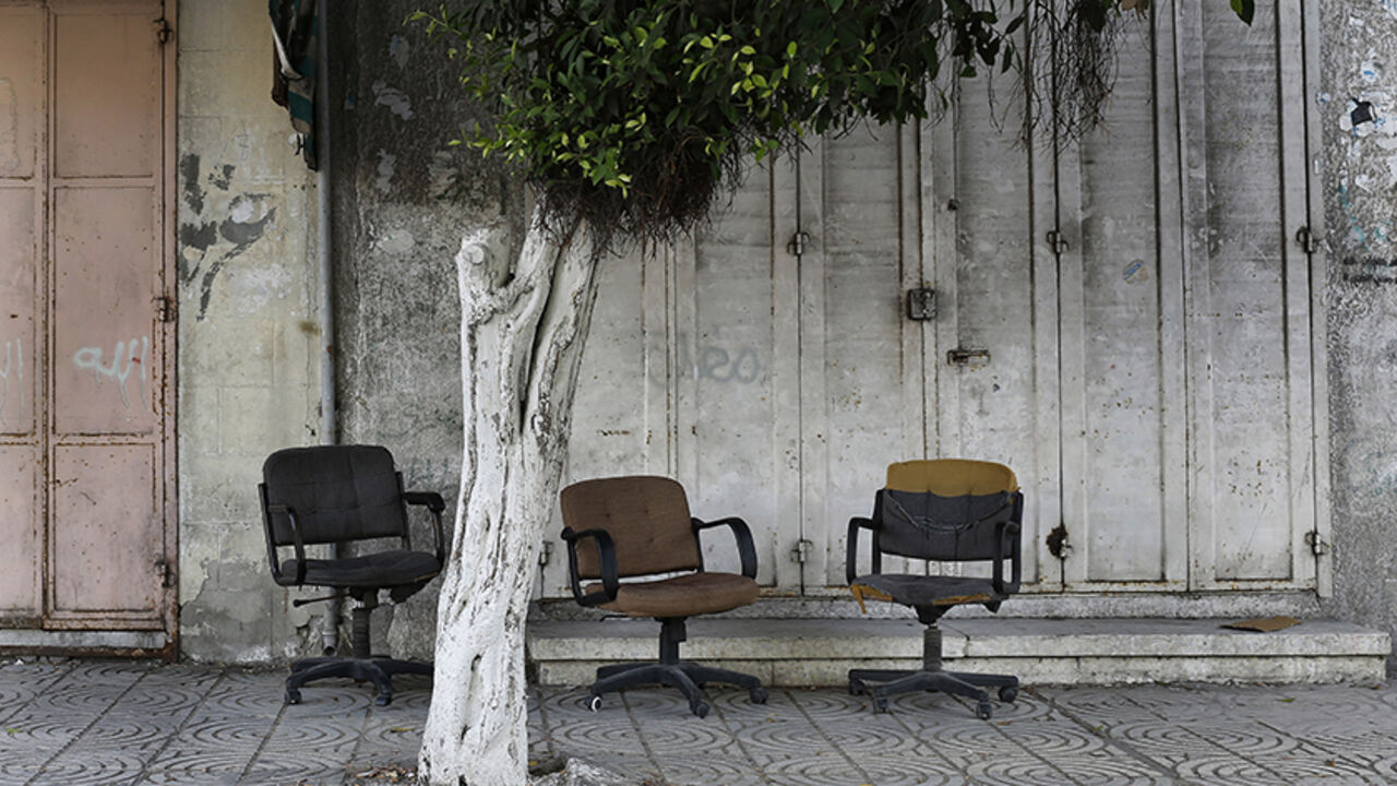 Office chairs sit abandoned in front of shuttered store fronts along a normally bustling commercial street in central Gaza City, July 19, 2014. Israel's month-long war against Hamas, with Israel carrying out air strikes, artillery bombardments and ground operations in response to constant militant rocket fire and attacks via tunnels, left more than 2,000 Palestinians dead, most of them civilians, as well as 64 Israeli soldiers and three civilians. It was the deadliest war in Gaza since Israel unilaterally w