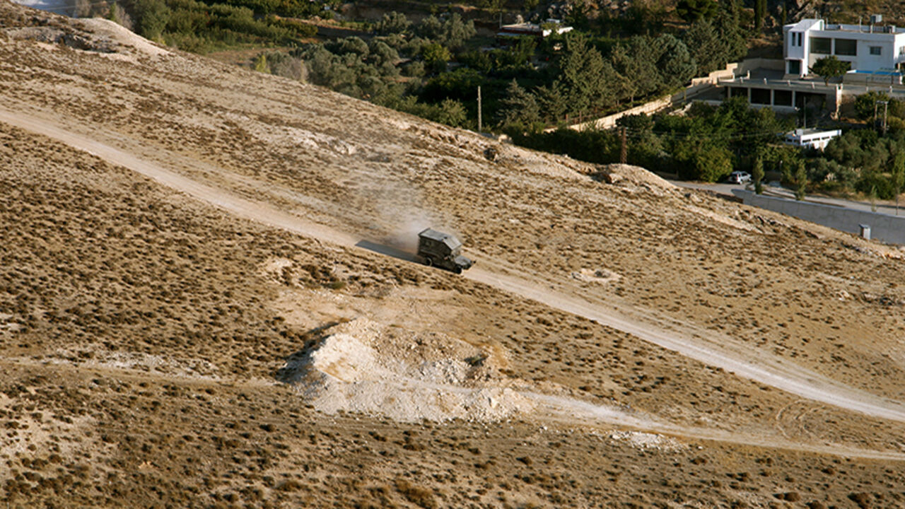 SYRIA-CRISIS/ A Lebanese Army vehicle drives down a mountain next to Ras-Baalbek, a Christian village on the outskirts of Arsal, August 30, 2014. Lebanese Christian fighters from three Christian villages that surround Arsal have been training for about three years and guarding their villages for the past year fearing a violent spillover from nearby Arsal, which is controlled by Islamic militias, according to the fighters. Picture taken August 30, 2014. REUTERS/Alia Haju (LEBANON - Tags: POLITICS CIVIL UNREST MILITARY) -