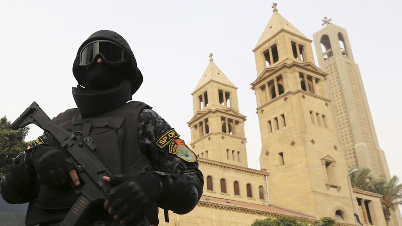 EGYPT-CHRISTIANS/ A special forces police officer stands guard to secure the area around Saint Mark's Coptic Orthodox Cathedral before a Coptic Christmas mass in Cairo January 6, 2015. Egypt's Coptic Christmas falls on Wednesday and security is typically tightened at churches ahead of the holiday after a string of attacks on Christian targets over the past years. REUTERS/Mohamed Abd El Ghany (EGYPT - Tags: RELIGION MILITARY CIVIL UNREST) - RTR4K8RY