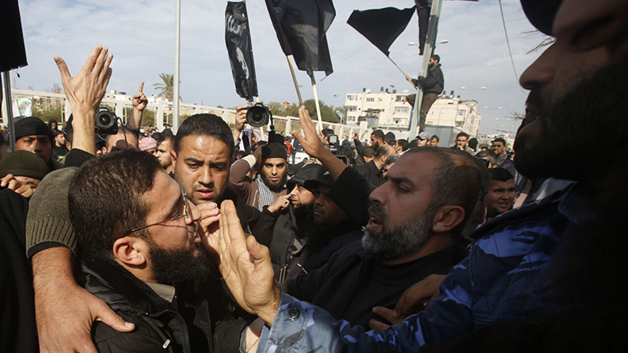 FRANCE-SHOOTING/PALESTINIANS Palestinian police officers loyal to Hamas push back Salafists during a protest against satirical French weekly magazine Charlie Hebdo's cartoons of the Prophet Mohammad, outside the French Cultural Centre in Gaza city January 19, 2015. Dozens of Jihadist Salafi men rallied in Gaza on Monday to condemn continued publication by French satirical magazine Charlie Hebdo of cartoons deemed offensive to Islam's Prophet. Charlie Hebdo published a picture of Mohammad weeping on its cover last week after gunmen stor