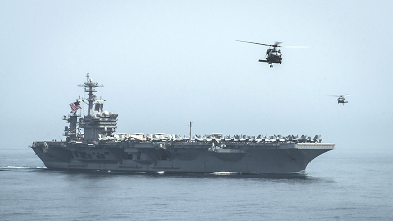US-YEMEN-SECURITY-USA-NAVY Helicopters fly from the aircraft carrier USS Theodore Roosevelt (CVN 71) during a resupply mission with the aircraft carrier USS Carl Vinson (CVN 70) in this U.S. Navy handout picture taken in the Gulf of Oman April 13, 2015 and released April 20, 2015. The U.S. Navy sent the carrier USS Theodore Roosevelt and its escort cruiser, USS Normandy, from the Gulf into the Arabian Sea on Sunday. Army Colonel Steve Warren, a Pentagon spokesman, denied reports the ships were on a mission to intercept Iranian arms