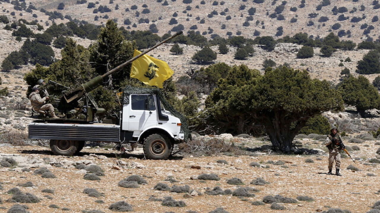 MIDEAST-CRISIS/SYRIA Lebanon's Hezbollah fighters rest on the back of a pick-up truck with an installed weapon in Khashaat, in the Qalamoun region after they advanced in the area May 15, 2015. Lebanon's Hezbollah and Syria's army made big advances against insurgents in mountains north of Damascus on Wednesday, Hezbollah and Syrian state media said, shoring up President Bashar al-Assad's grip on the border zone. REUTERS/Mohamed Azakir - RTX1D54Z