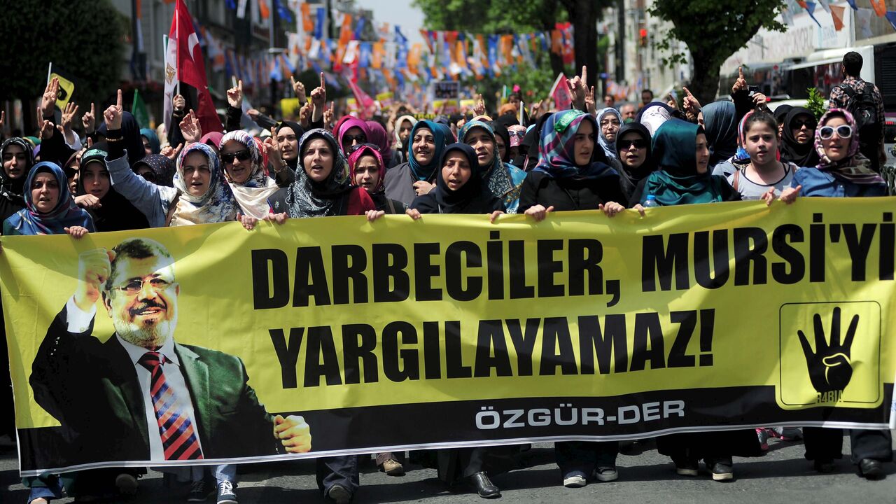 EGYPT-COURT/MURSI Pro-Islamist demonstrators hold a banner that reads "Coup leaders can't trial Mursi" during a protest in support former President Mohamed Mursi at the courtyard of Fatih mosque in Istanbul, Turkey, May 17, 2015. An Egyptian court on Saturday sought the death penalty for former president Mohamed Mursi and 106 supporters of his Muslim Brotherhood in connection with a mass jail break in 2011. Mursi and his fellow defendants, including top Brotherhood leader Mohamed Badie, were convicted for killing and kidnapp