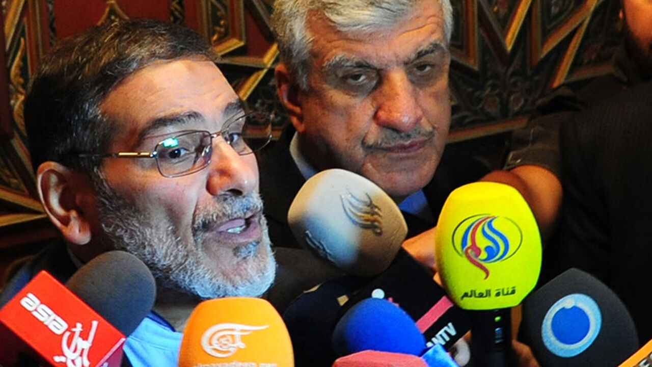 Nic6374141 Iranian secretary of the Supreme National Security Council, Ali Shamkhani (L) speaks to reporters at the Damascus airport on September 30, 2014. AFP PHOTO/ STR (Photo credit should read STR/AFP/Getty Images)