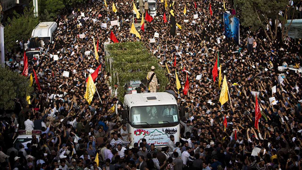 Nic6461946 Iranians follow trucks carrying coffins towards Tehran's Baharestan square on June 16, 2015 during a funeral procession for 270 victims of the Iran-Iraq war (1980-1988) (175 of them belonging to a group of military divers), a month after their bodies were repatriated to Iran. The divers were responsible for breaking the enemy lines during an operation in 1986 with the aim of taking Basra in southern Iraq, but the operation was discovered by the Iraqi army that killed a large number of Iranian military and m