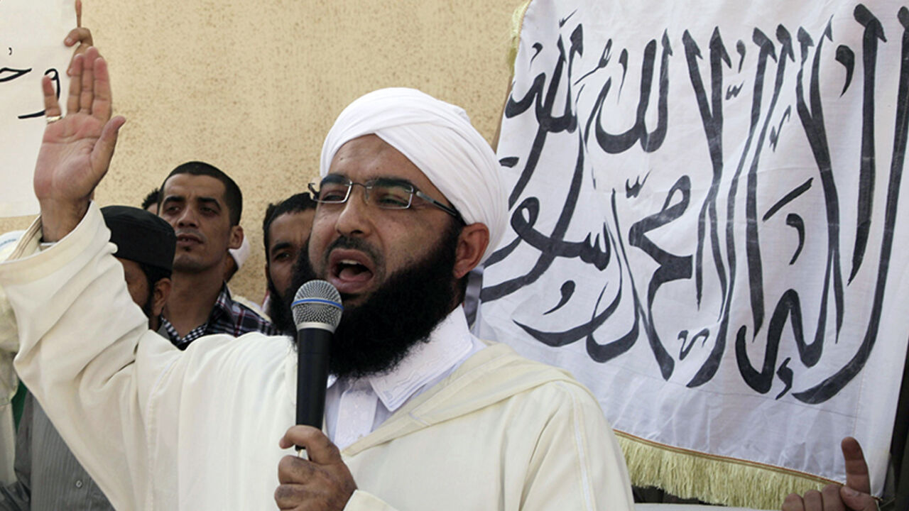FILM-PROTESTS/MOROCCO Moroccan Salafist preacher Hassan al-Kettani speaks during a demonstration against an anti-Islam film made in the U.S. that mocks the Prophet Mohammad outside a mosque in the impoverished Rahma neighbourhood of Sale, September 21, 2012. The banner reads, "There is only one God and Mohammad is his prophet". REUTERS/Stringer (MOROCCO - Tags: RELIGION CIVIL UNREST) - RTR3890E