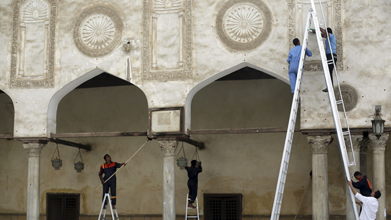 EGYPT-SISI/RELIGION Men carry out cleaning work at Al-Azhar Mosque, in the old Islamic area of Cairo May 8, 2014. As the Egyptian state presses its crackdown on the Muslim Brotherhood, the man expected to become president has deployed a new weapon in the battle with the Islamists: his own vision of Islam. Sisi, the former army chief who deposed the Brotherhood's Mohamed Mursi and is expected to be elected president later this month, has cast himself as a defender of religion and taken aim at the doctrinal foundations of Islami