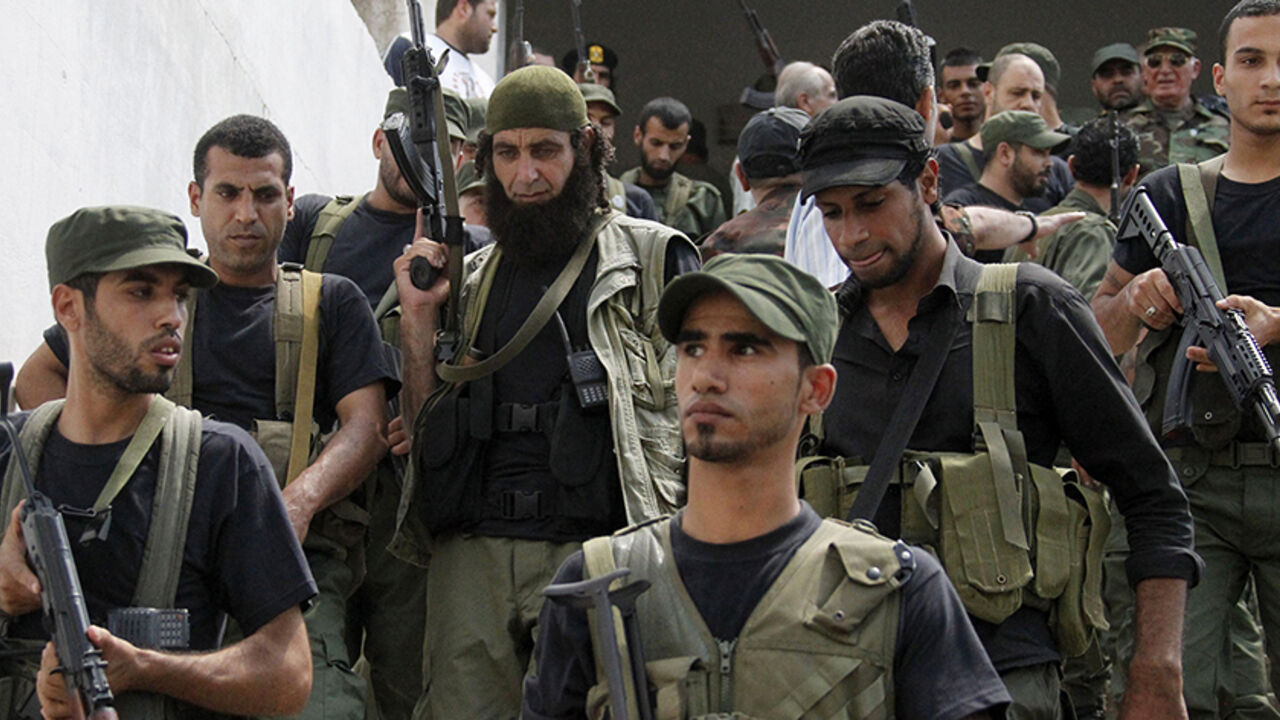 Palestinian gunmen from different factions hold their weapons during the launch of a joint security force that includes all Palestinian factions, to maintain stability at the Ain al-Hilweh Palestinian refugee camp near the port-city of Sidon, southern Lebanon July 8, 2014.
REUTERS/Ali Hashisho (LEBANON - Tags: POLITICS MILITARY) - RTR3XMS5