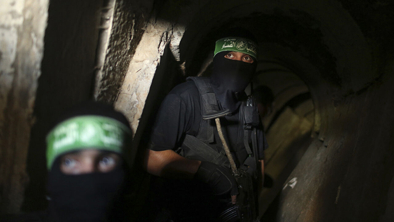 MIDEAST-GAZA/TUNNELS Palestinian fighters from the Izz el-Deen al-Qassam Brigades, the armed wing of the Hamas movement, are seen inside an underground tunnel in Gaza August 18, 2014. A rare tour that Hamas granted to a Reuters reporter, photographer and cameraman appeared to be an attempt to dispute Israel's claim that it had demolished all of the Islamist group's border infiltration tunnels in the Gaza war. Picture taken August 18, 2014. REUTERS/Mohammed Salem (GAZA - Tags: POLITICS CONFLICT TPX IMAGES OF THE DAY) - RTR42YJR