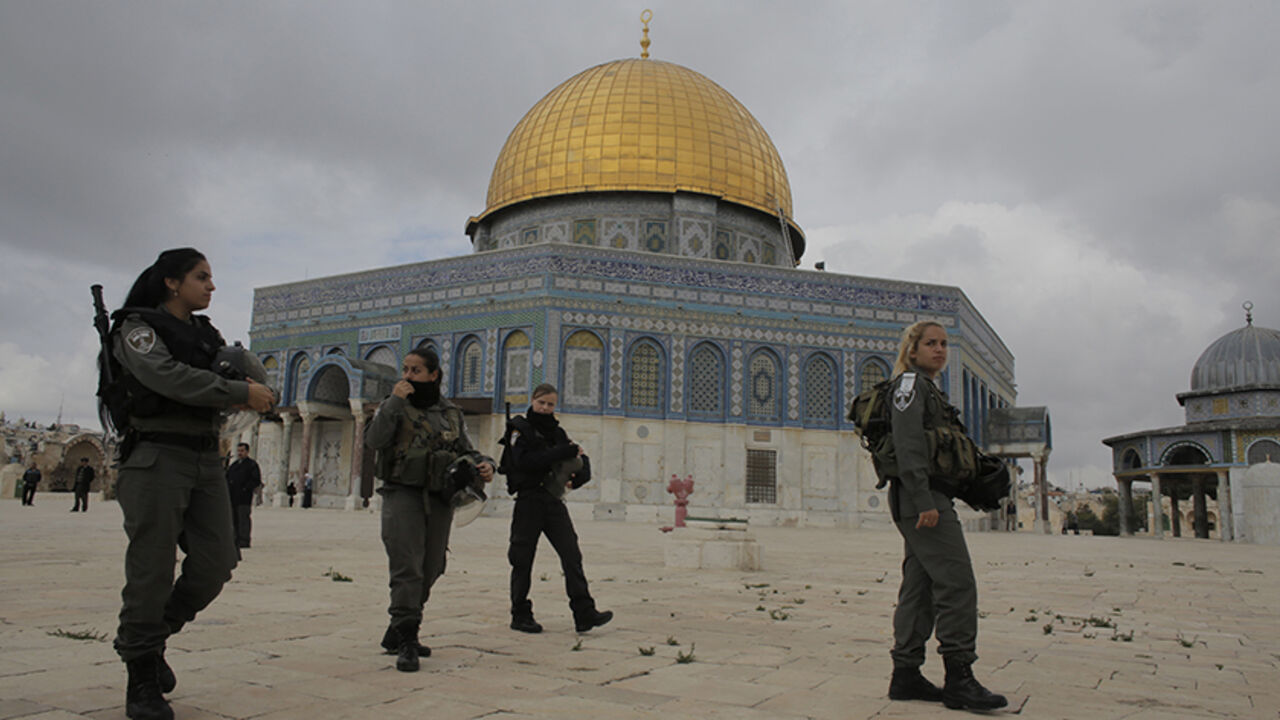 MIDEAST-JERUSALEM/VIOLENCE Israeli border police officers walks in front of the Dome of the Rock on the compound known to Muslims as Noble Sanctuary and to Jews as Temple Mount in Jerusalem's Old City November 5, 2014. Israeli security forces hurling stun grenades clashed with Palestinian stone-throwers at al-Aqsa mosque - a confrontation that has played out frequently over the past several weeks. REUTERS/Ammar Awad (JERUSALEM - Tags: POLITICS CIVIL UNREST RELIGION) - RTR4CY31