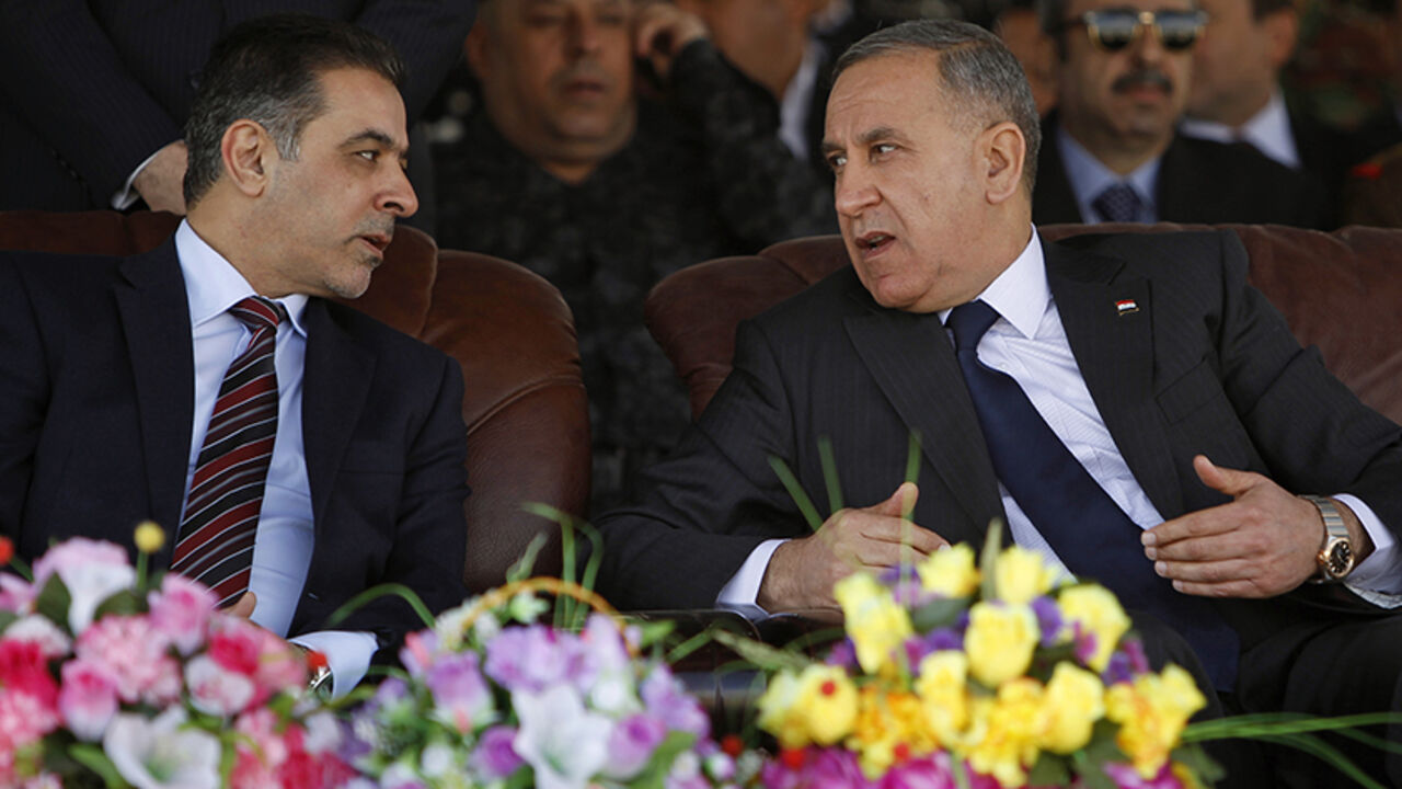 MIDEAST-CRISIS/IRAQ Iraqi Interior Minister Mohammed Salem al-Ghabban (L) and Iraq's Defence Minister Khaled al-Obeidi (R) attend a ceremony marking the Iraqi Police Day's 93rd anniversary at a police academy in Baghdad January 8, 2015. REUTERS/Ahmed Saad (IRAQ - Tags: CIVIL UNREST MILITARY ANNIVERSARY LAW) - RTR4KL0R