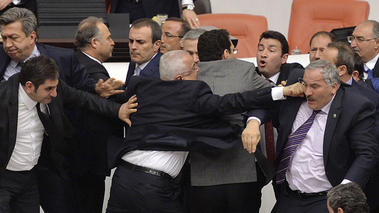 TURKEY-PARLIAMENT/FIGHT Main opposition Republican People's Party (CHP) and ruling AK Party (R) lawmakers scuffle during a debate on a legislation to boost police powers, at the Turkish Parliament in Ankara late February 19, 2015. The legislation, which would bolster the powers of the authorities to control protests, has been widely condemned by the opposition, who accuse the AKP of trying to create a police state in the NATO member nation. REUTERS/Stringer (TURKEY - Tags: CRIME LAW POLITICS TPX IMAGES OF THE DAY) - RTR4QBIU